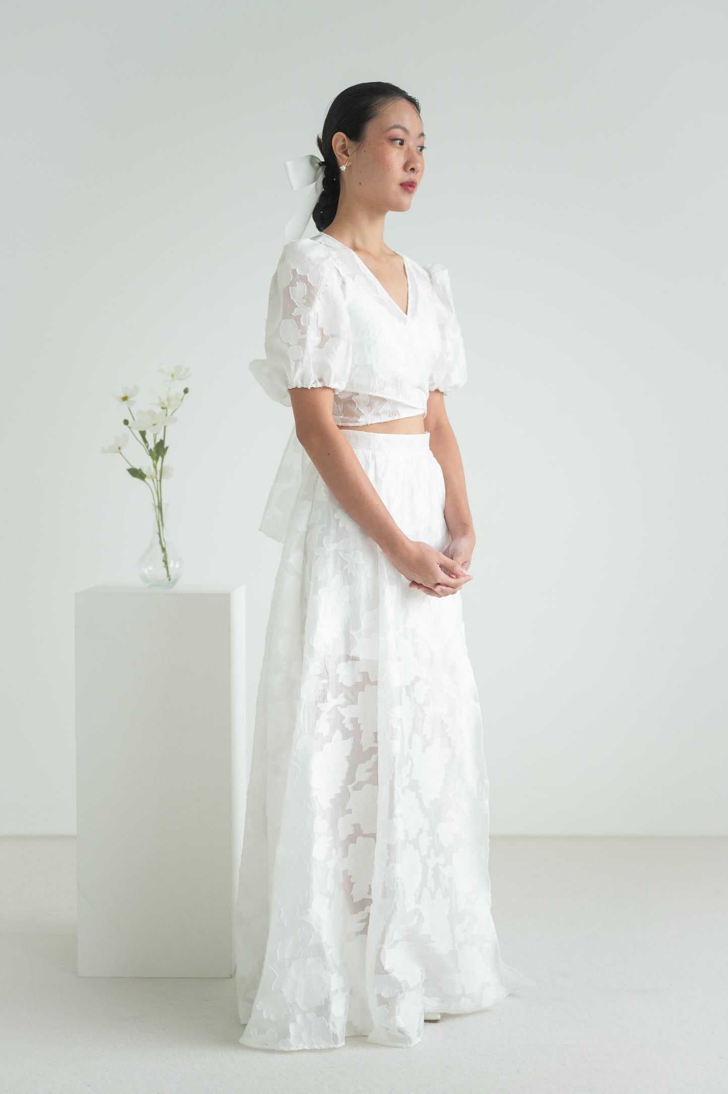 A sheer floral wrap top with short puffed sleeves and elastic cuffs.