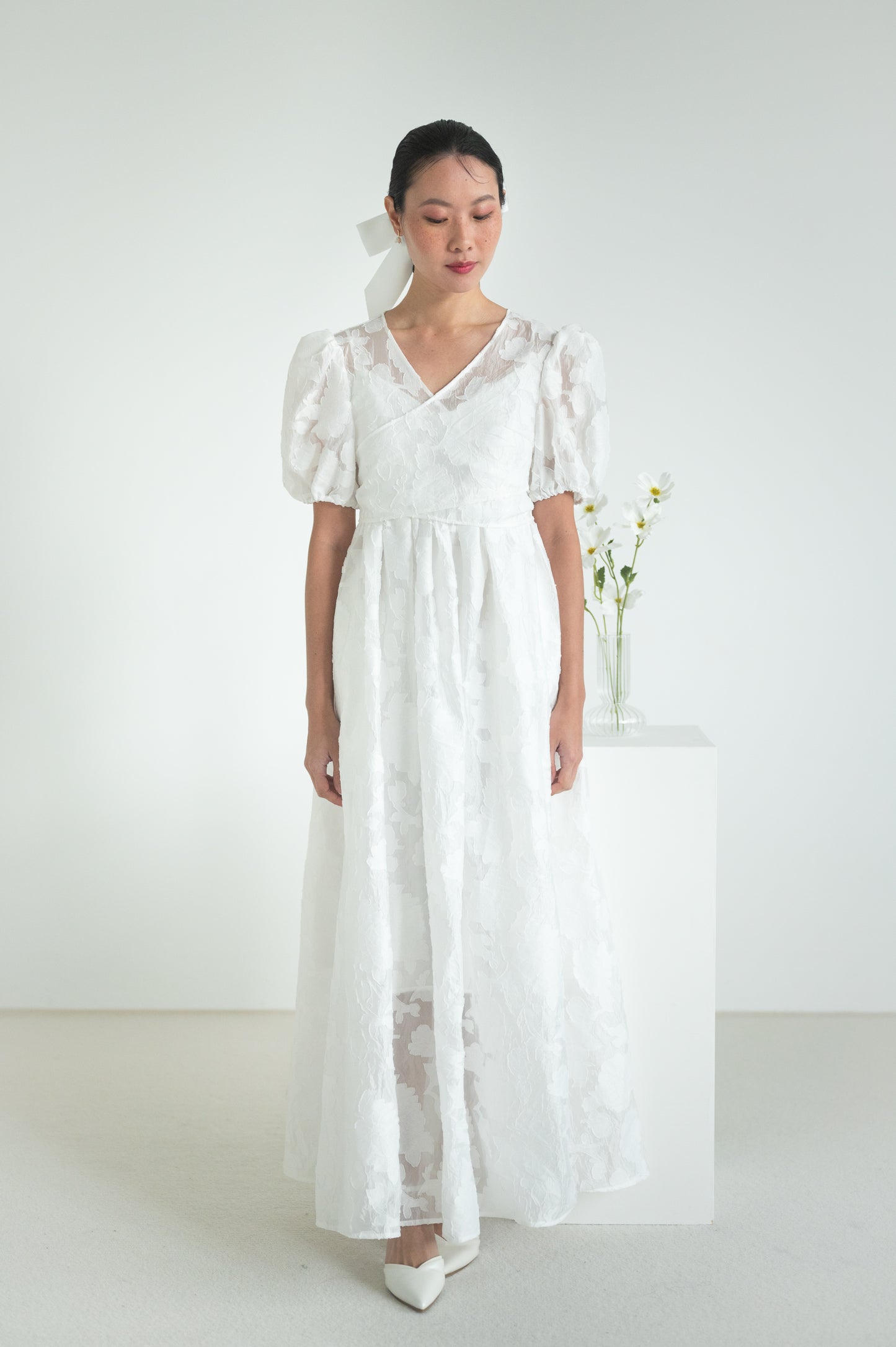 A sheer floral wrap top with short puffed sleeves and elastic cuffs.